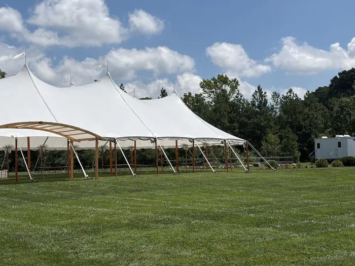 Clean Spot restroom trailer set up beside a sailcloth tent at a Maryland wedding reception