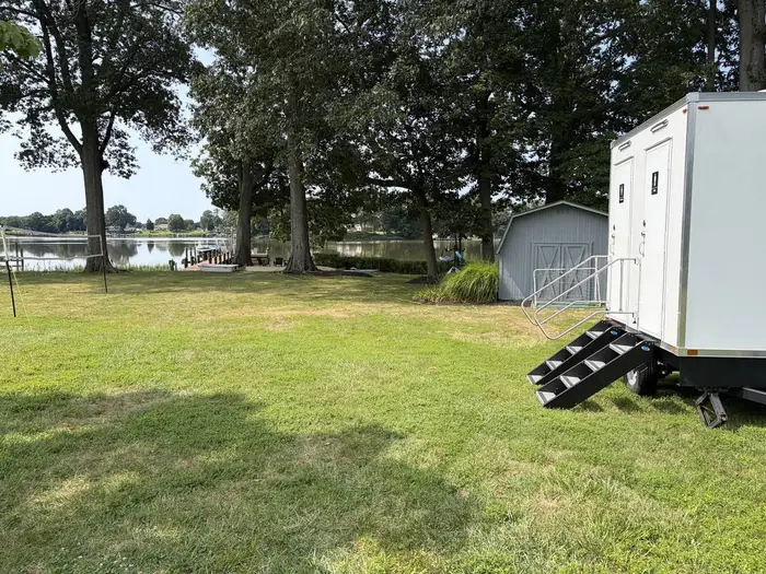 Restroom trailer set up on a waterfront back lawn for a backyard wedding near St. Michaels, Maryland