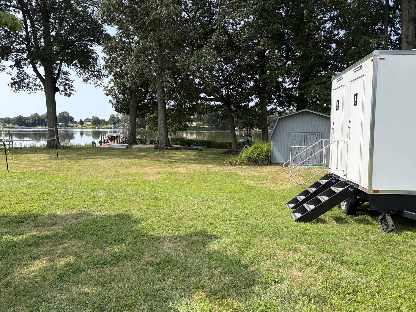 Restroom trailer set up on a waterfront back lawn for a backyard wedding near St. Michaels, Maryland